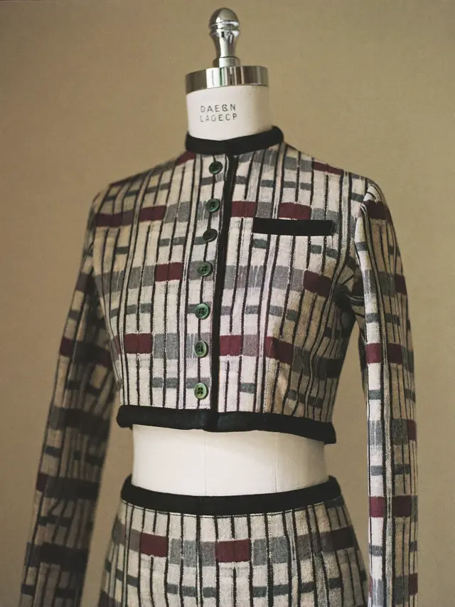 A tailored two-piece in patterned cloth on a dress form