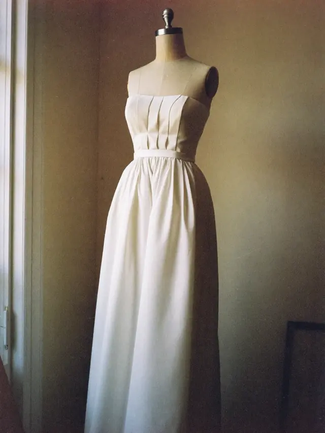An ivory bridal dress on a dress form